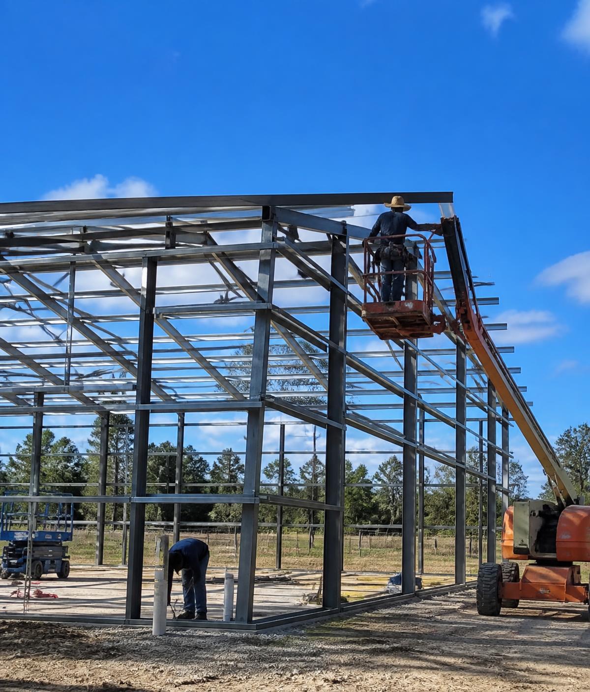Crew installing steel framing on a new metal building